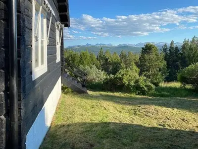 a house with a window on the side of it at Historic Timber Cabin With Views Of Rondane in Furuhovde