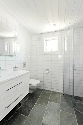 a white bathroom with a toilet and a sink at Stranda Fjellgrend 2 bedrooms and loft - 16B in Stranda