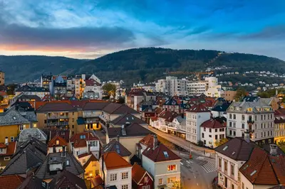 a view of a city with buildings and mountains at Modern 1BR in heart of old town in Bergen