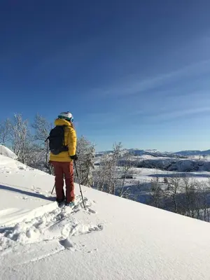 a person on skis standing on a snow covered slope at Ski slopes nearby - Parking & WiFi in Vossevangen