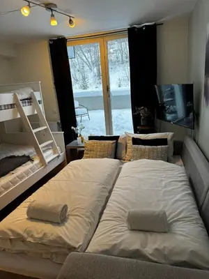 two large beds in a room with a window at Lake Resort - Pool & Sauna in Vossevangen