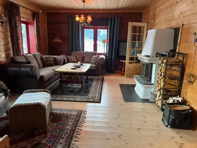 a living room with a couch and a fireplace at Authentic Norwegian Cabin - Sauna, Firehouse & Nature in Vossevangen