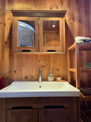 a kitchen with a sink and a microwave at Authentic Norwegian Cabin - Sauna, Firehouse & Nature in Vossevangen