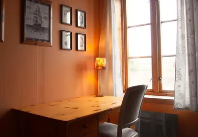 a wooden desk in a room with a window at Gunnabuda in Longva