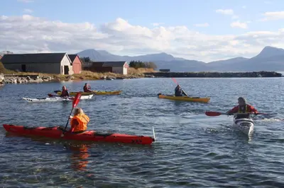 a group of people in kayaks on a body of water at Gunnabuda in Longva