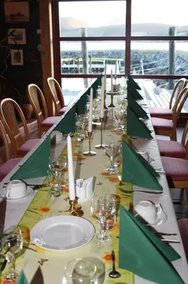 a long table with plates and glasses and candles at Gunnabuda in Longva
