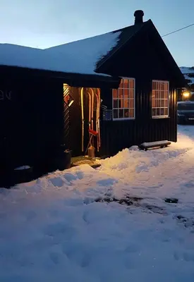a house with snow on the ground in front of it at Family Cabin Near Rallarvegen And Geilo in Ustaoset