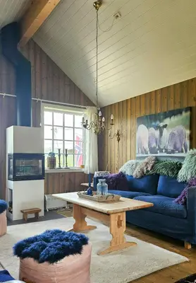 a living room with a blue couch and a table at Family Cabin Near Rallarvegen And Geilo in Ustaoset