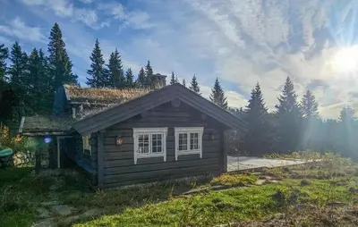 a small log cabin with a window in a yard at Cozy Home In Eggedal With Wifi in Eggedal