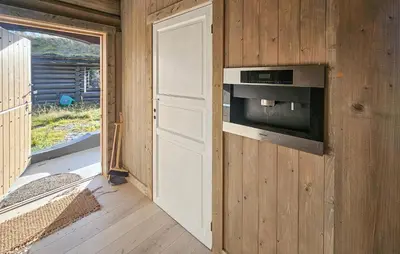 a kitchen with a wall with a microwave and a door at Cozy Home In Eggedal With Wifi in Eggedal