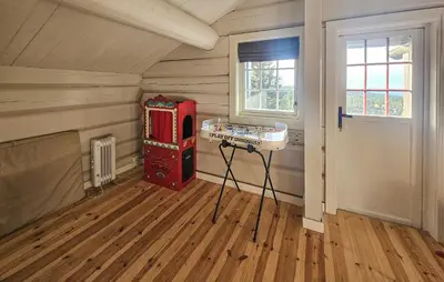 a room with a red machine in the corner of a room at Cozy Home In Eggedal With Wifi in Eggedal