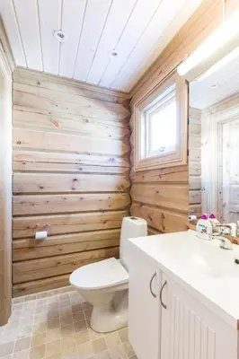 a bathroom with wooden walls and a toilet and a sink at Stranda Fjellgrend 3 bedrooms - 68B in Stranda