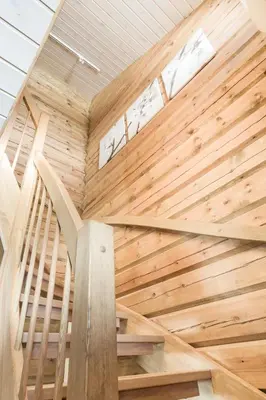 a wooden staircase in a house with a wooden wall at Stranda Fjellgrend 3 bedrooms - 68B in Stranda