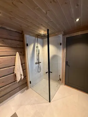 a shower in a bathroom with a glass door at New exclusive cabin - panoramic view with ski in-out, Kvitfjell Varden in Ringebu