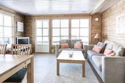 a living room with a couch and a table at Stranda Fjellgrend 3 bedrooms - 68A in Stranda