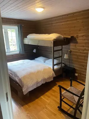 a bedroom with two bunk beds in a log cabin at Stranda Fjellgrend 3 bedrooms - 29C in Stranda