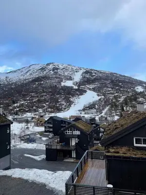 a view of a town with a snow covered mountain at Stranda Fjellgrend 3 bedrooms - 29C in Stranda