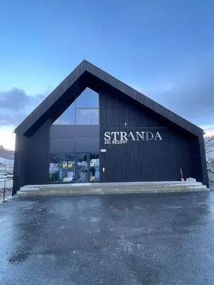 a building with a sign on the side of it at Stranda Fjellgrend 3 bedrooms - 29C in Stranda