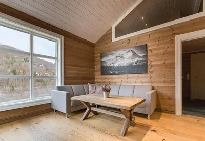 a living room with a table and a couch at Stranda Fjellgrend 3 bedrooms and loft - 80D in Stranda