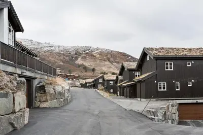 an empty street in a town with houses and a mountain at Stranda Fjellgrend 3 bedrooms and loft - 80D in Stranda