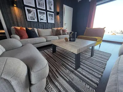 a living room with a couch and a coffee table at Winter cabin with Jacuzzi in Trysil