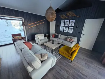 a living room with a couch and chairs and a table at Winter cabin with Jacuzzi in Trysil