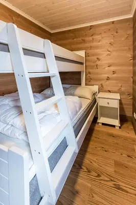 a bedroom with bunk beds in a log cabin at Stranda Fjellgrend 3 bedrooms and loft - 80C in Stranda