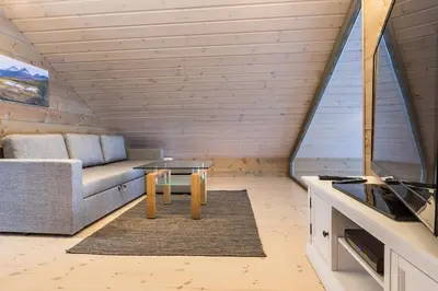 a living room with a couch and a table at Stranda Fjellgrend 2 bedrooms and loft - 30B in Stranda