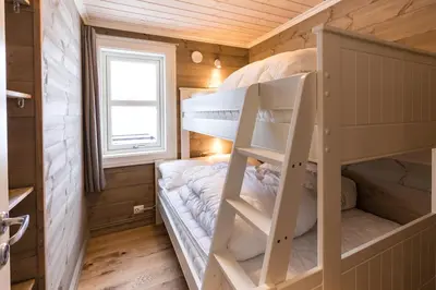 a bedroom with bunk beds in a tiny house at Stranda Fjellgrend 2 bedrooms and loft - 30B in Stranda