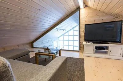 a living room with a large flat screen tv at Stranda Fjellgrend 2 bedrooms and loft - 30B in Stranda