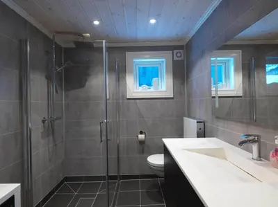a bathroom with a shower and a toilet and a sink at Stranda Fjellgrend 3 bedrooms - 32A in Stranda