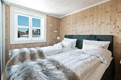 a large bed in a room with a window at Stranda Fjellgrend 2 bedrooms and loft - 32B in Stranda