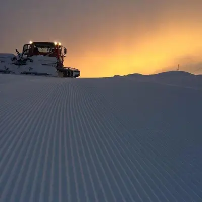 a snow truck parked on top of a snow covered field at Luster Lodge in Luster