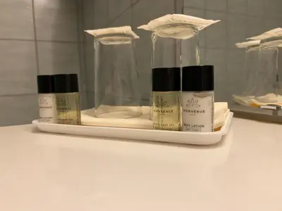 a shelf with three bottles of moisturizers on a bathroom counter at Park Hotel Vossevangen in Vossevangen