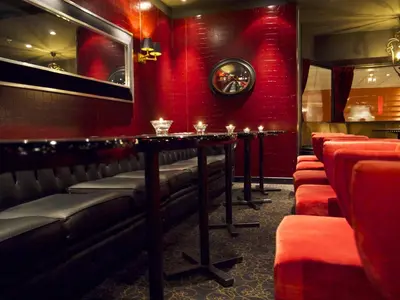 a bar with red walls and a table with candles at Park Hotel Vossevangen in Vossevangen