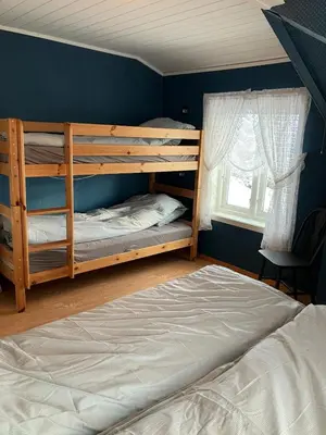 a bedroom with two bunk beds and a bed at Holiday home in Espevær in Bømlo
