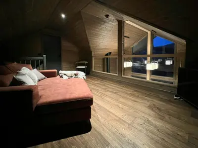 a living room with a couch and a large window at Warm And Inviting Cabin Near Norefjell in Eggedal
