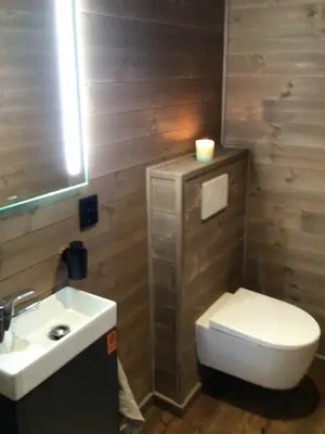 a bathroom with a toilet and a sink at Warm And Inviting Cabin Near Norefjell in Eggedal