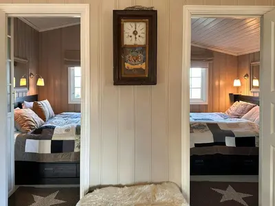a room with two beds and a clock on the wall at Mountain Cabin With Magical Views At Dagalifjell in Uvdal