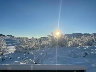 a light pole in the snow with the sun behind it at Mountain Cabin With Magical Views At Dagalifjell in Uvdal