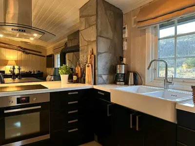 a large kitchen with a sink and a window at Mountain Cabin With Magical Views At Dagalifjell in Uvdal