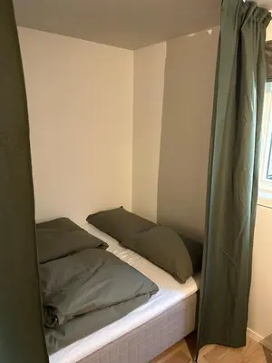 a bed in a room with two pillows at Villa Hagavik, studio apartment Peter