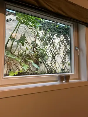 a window on a door with a fence at Villa Hagavik, studio apartment Peter