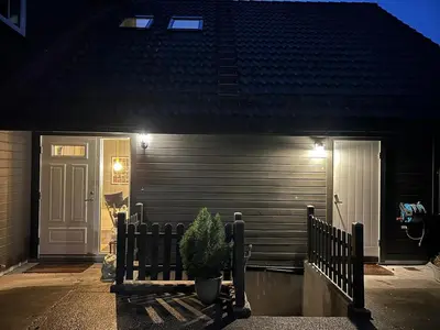 a house with a potted plant in front of a door at Villa Hagavik, studio apartment Peter