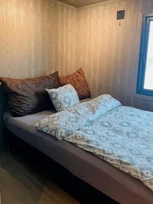 a bed with pillows on it in a room at Opplev Den Unike Stemningen På Golsfjellet in Gol