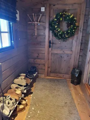 a room with a bunch of shoes in front of a door at Bjorlicabin in Bjorli