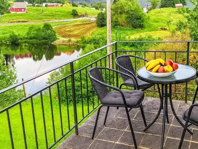 a table and chairs on a balcony with a bowl of fruit at Apartment Samlen Vasselgård by Interhome in Herand