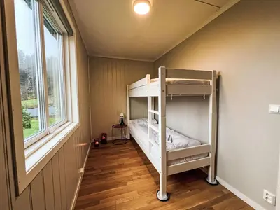 a bunk bed in a room with a window at Apartment Samlen Vasselgård by Interhome in Herand