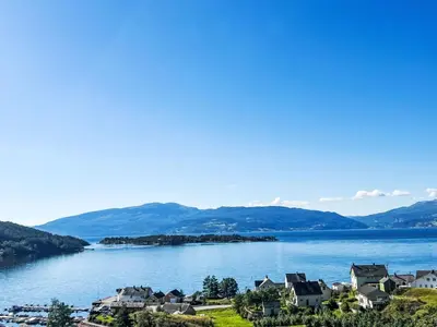 a view of a lake with houses and mountains at Apartment Samlen Vasselgård by Interhome in Herand