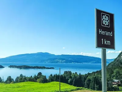 a sign on a hill with a view of a lake at Apartment Samlen Vasselgård by Interhome in Herand